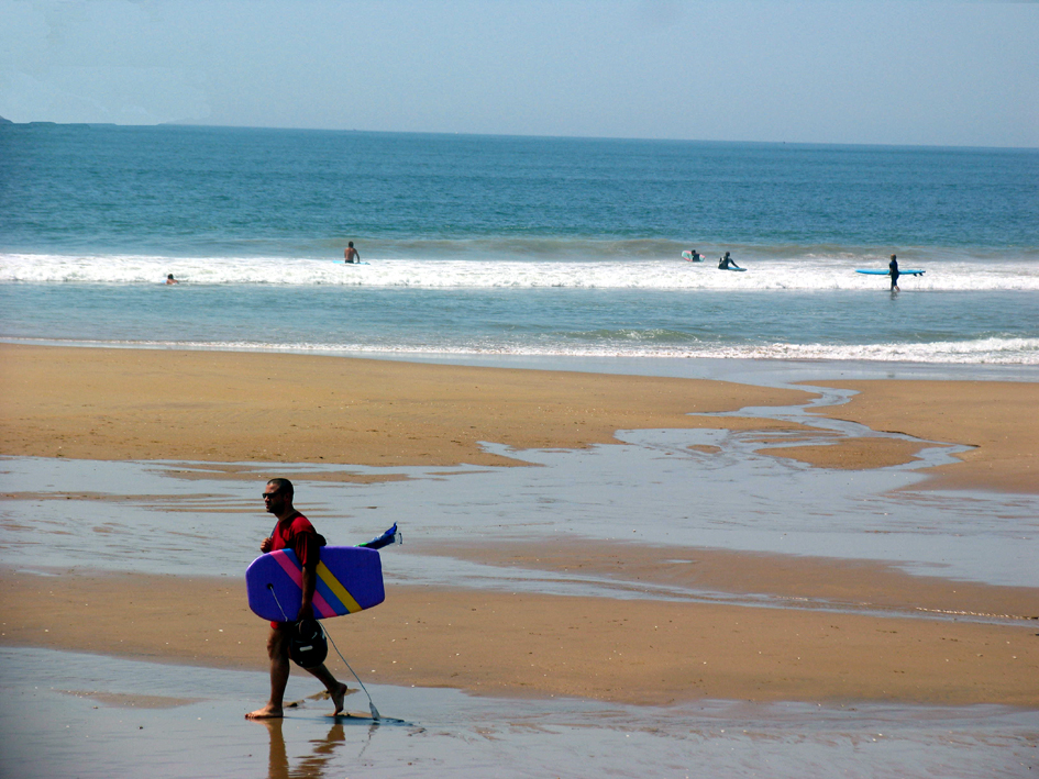 Surfers on the beach at Les Conches